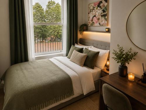 a bedroom with a bed and a window and a desk at Castle Mount Apartments in Sandal and Walton