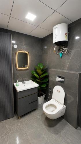 a bathroom with a toilet and a sink at Skyline suites in Noida