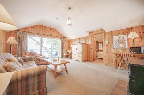 a living room with a couch and a table at Lakefront Cottage Private Beach & & Kayaks in Georgina