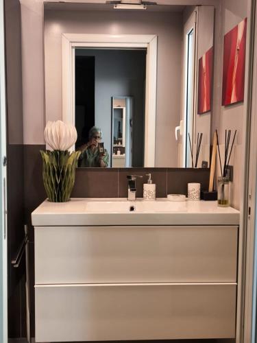 a man taking a picture of a bathroom sink at L'Angolino Nascosto in Senigallia
