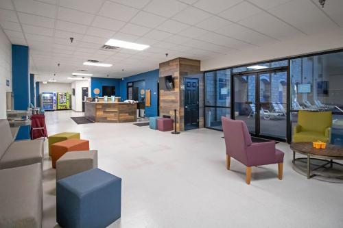 a lobby with colorful chairs and tables in a building at Massanutten's Regal Vistas by TripForth in McGaheysville