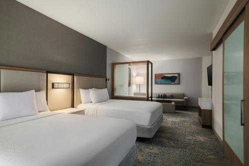 a hotel room with two beds and a couch at SpringHill Suites by Marriott Abilene in Abilene