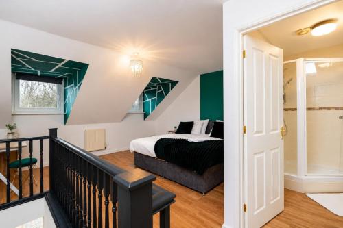 a bedroom with a king sized bed and a staircase at Large 3 bed Double Driveway Smart TVLong Stays in Durham