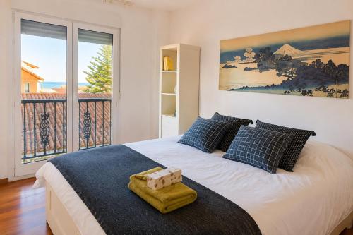 a bedroom with a bed and a large window at Dunas de Corrubedo in Ribeira