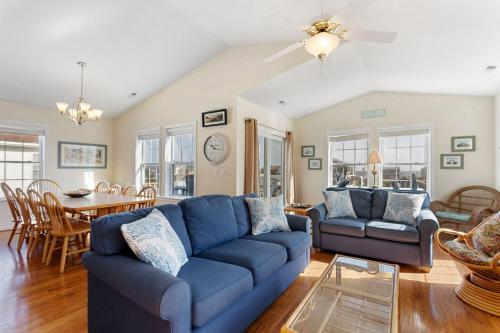 a living room with a blue couch and a table at 6150 - B Groove Inn (formerly Pelican Crest) in Nags Head