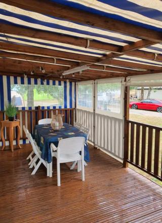 a dining area with a table and chairs in a room at Mobile Home in Morbier