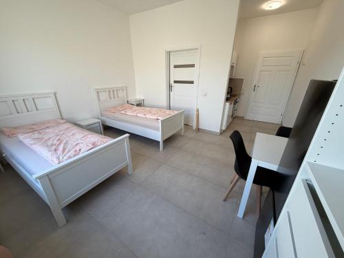 a bedroom with two beds and a desk and a desk at Private Room in Hannover