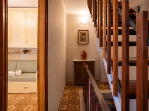 a hallway with a room with a bed and stairs at La Dimora Sulla Collina Micciani Rieti in Micciani