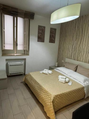 a bedroom with a bed with two towels on it at Matera Central Nest in Matera