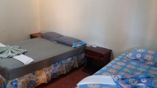 Postel nebo postele na pokoji v ubytování Hostal Nathaly