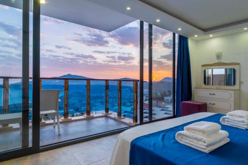 a bedroom with a view of the ocean at Villa Panorama Kalkan Jilda Livya in Kalkan
