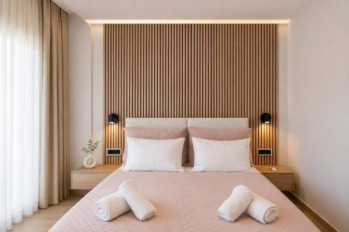 a bedroom with a large bed with white pillows at Chara’s Luxury home in Kalabaka