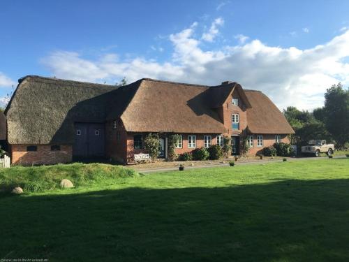 a large brick house with a grass roof at Emes Stuuv in Oevenum