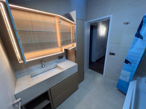 a bathroom with a sink and a mirror at Casa Natura Flassia de 240m2 con piscina privada in Vidreres
