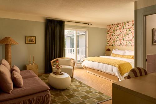 a living room with a bed and a couch at The June Motel, Prince Edward County in Picton