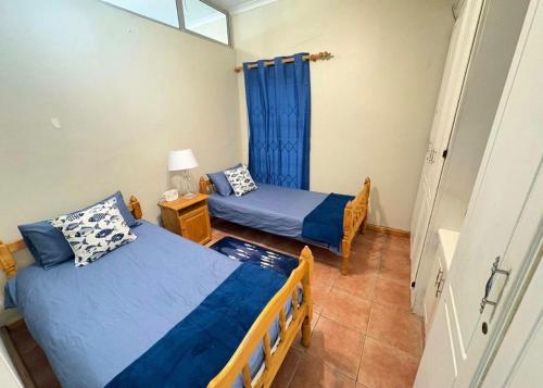 a bedroom with two beds and a window at Kei Sands Nr 6 in Kei-mouth Village