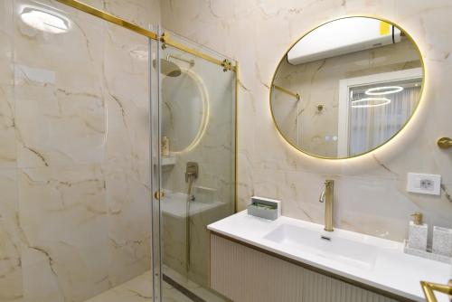 a bathroom with a shower and a sink and a mirror at Dream Palace 2 in Belgrade