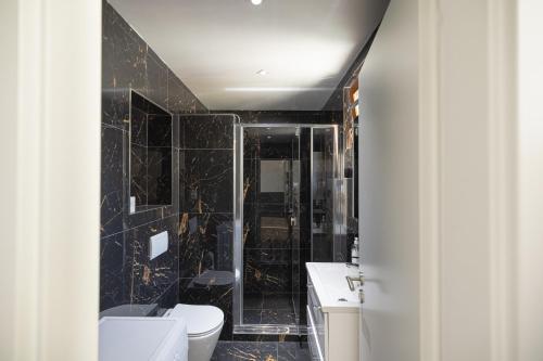 a bathroom with a toilet and a sink and a shower at L&S House in Prague