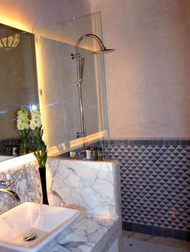 a bathroom with a sink and a shower at Riad Dar Dar in Rabat