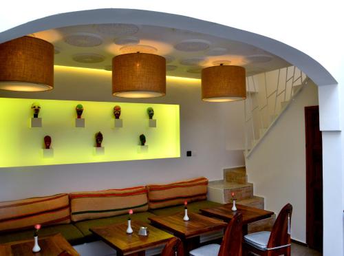 a restaurant with tables and a couch and lights at Riad Dar Dar in Rabat