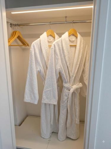 a closet with white towels hanging in it at Studio Bulle de Rêve à deux pas du Port in Nice
