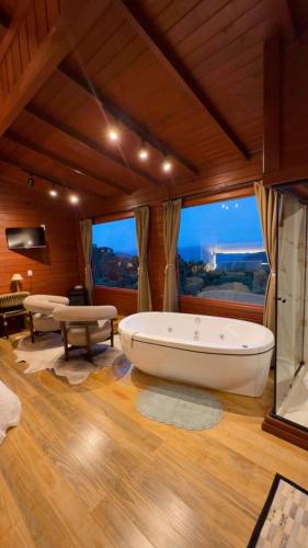 a large bathroom with a large tub in a room at IL Rifugio Cabanas in Urubici