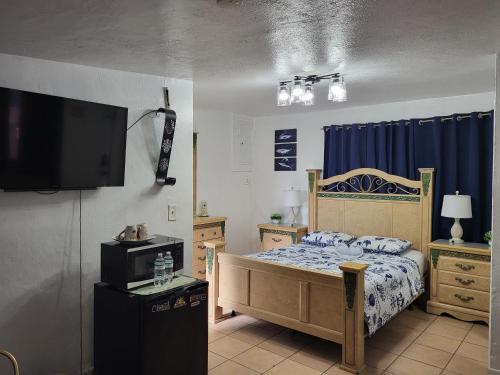 a bedroom with a bed and a tv on the wall at Coco Sol 3 by MyMiamiStay in Miami