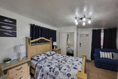 a bedroom with a bed and a blue chair at Coco Sol 3 by MyMiamiStay in Miami