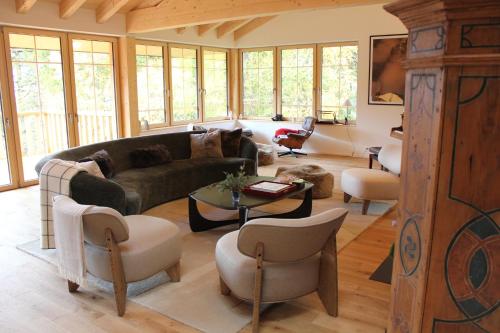 a living room with a couch and chairs at La Tzoumaz Lodge in La Tzoumaz