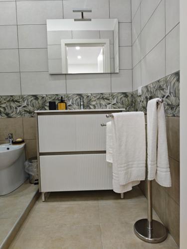 a bathroom with white towels and a sink at Dream Rooms Palomonte 