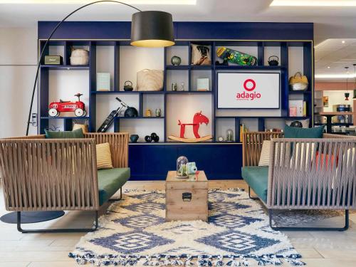 a store with two chairs and a tv in a room at Aparthotel Adagio Aix-en-Provence Centre in Aix-en-Provence