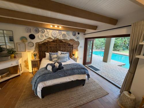 a bedroom with a large bed and a pool at The Bryanston Boutique in Johannesburg