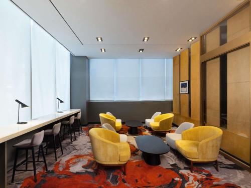 a meeting room with yellow chairs and a table andools at ibis Ambassador Seoul Insadong-Newly renovated in 2025 in Seoul