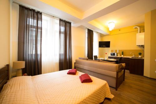 Ένα ή περισσότερα κρεβάτια σε δωμάτιο στο Aparthotel Na Mytniy