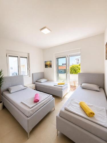 a large room with two beds and a couch at Montebello Inn apartments in Ulcinj