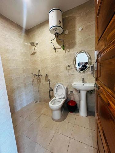 a bathroom with a toilet and a sink at The lake house in Bhīm Tāl