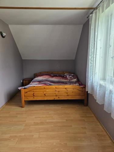 a bed in a room with a window at Dom w Zbychowie in Gniewowo
