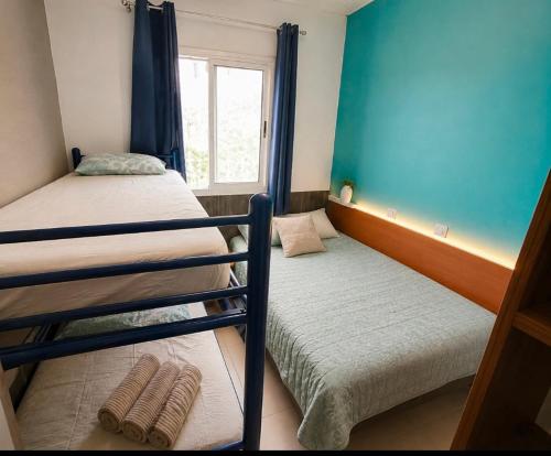 two bunk beds in a room with a window at Guesthouse Tossa de Mar in Tossa de Mar