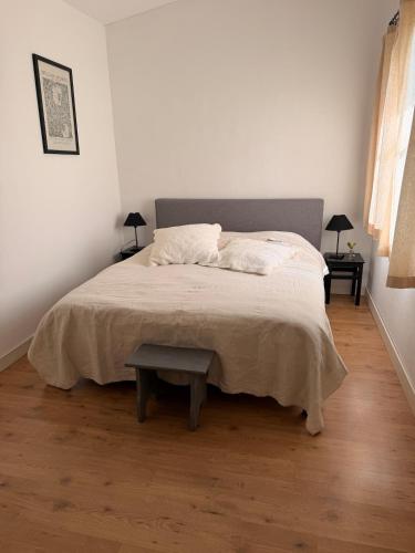 a bedroom with a large bed with a table at Chateau de Salorges - Field gite I in Corancy
