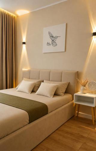a bedroom with a bed in a room with lights at Ауельбекова 120 in Kokshetau