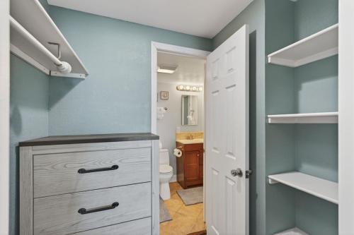 a bathroom with a sink and a toilet in a room at Oceanfront Beach Condo, Pool, Gym, Fishing Surfing in Virginia Beach