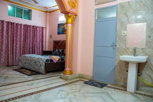 a bathroom with a shower and a sink and a bed at Residency Trilok in Varanasi