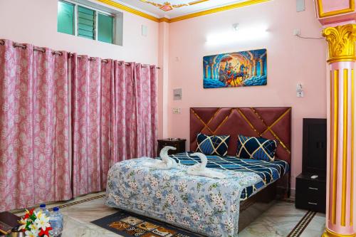 a bedroom with a bed with swans on it at Residency Trilok in Varanasi