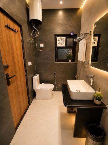 a bathroom with a sink and a toilet in it at Hotel Aaradhya Residency in Agra
