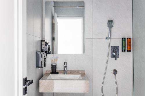 a bathroom with a sink and a shower at Marmaris Saray Hotel DOWNTOWN in Tashkent