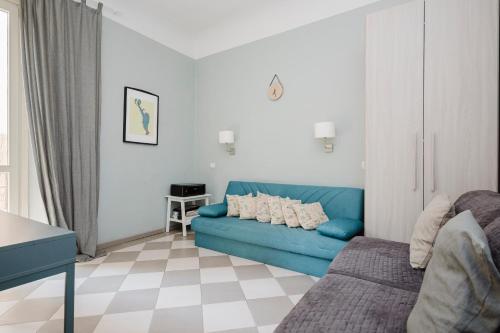 a living room with a blue couch and a table at Cavour 96 Apartment in Florence