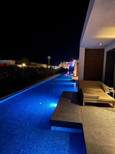 a swimming pool at night next to a building at SeaBreeze White Villa 42 in Nardaran