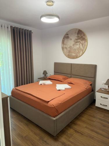 a bedroom with a bed with two towels on it at Topuzi Grand House in Pogradec