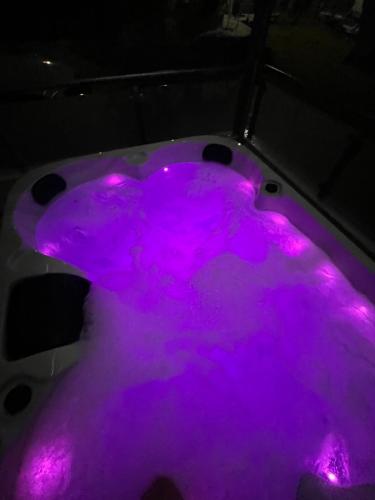 a hot tub with purple lights in a room at AMORÉA Jacuzzi Suites Evia in Eretria