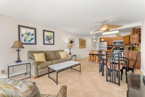 a living room with a couch and a table at Kihei Akahi D-104 in Wailea